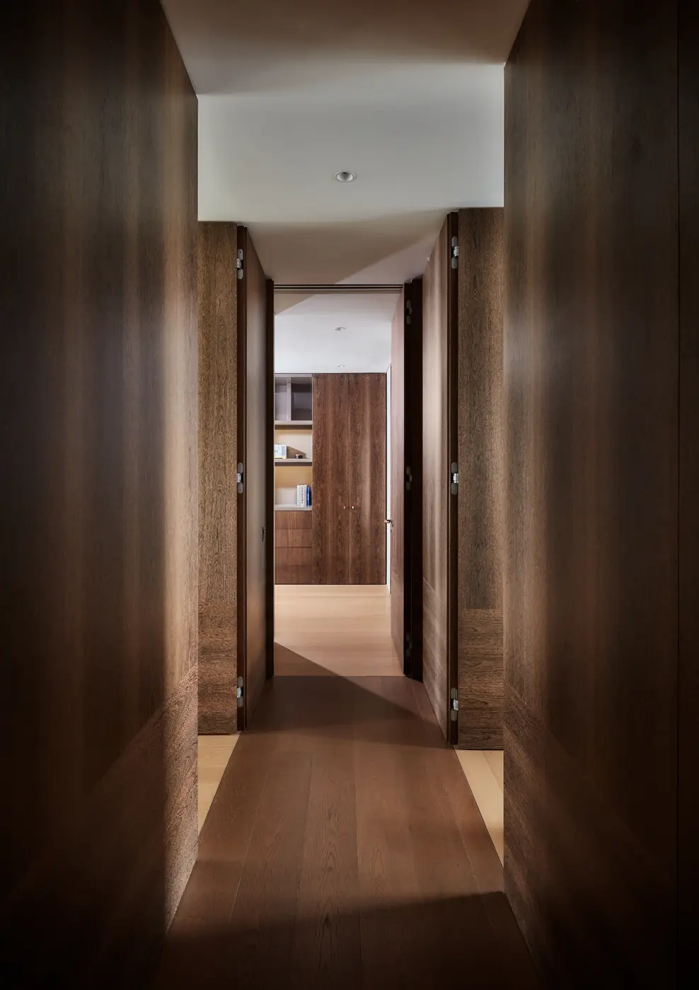 Private corridor lined with dark timber cladding