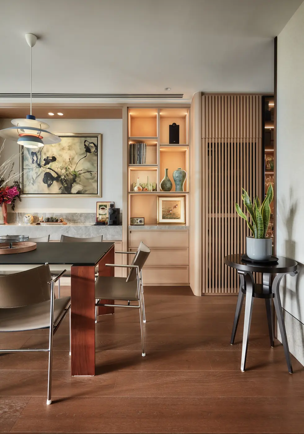 Dining from an angle showing shelving and artwork