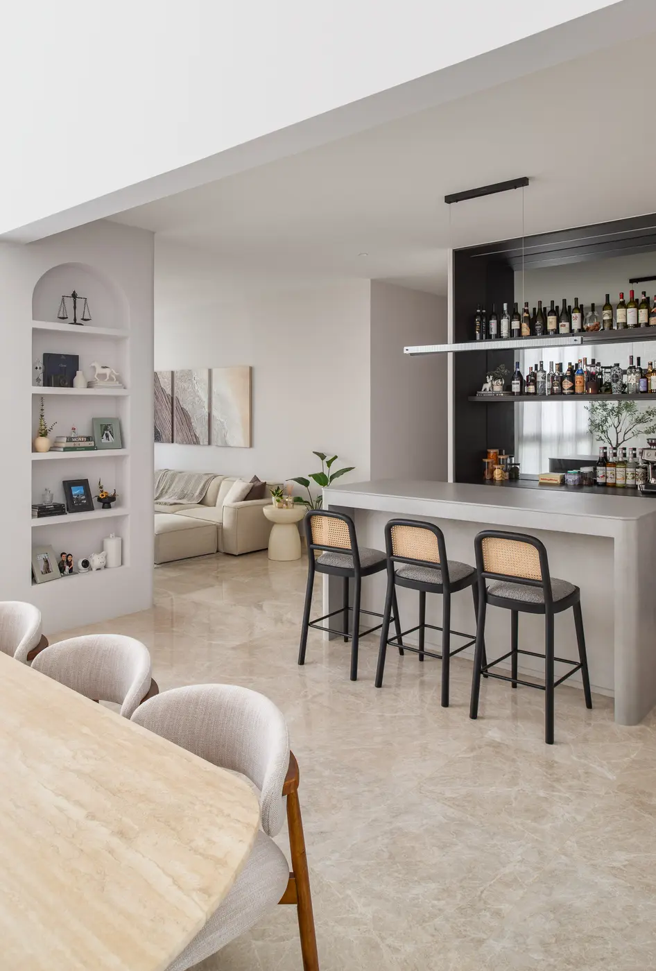 Living room — full depth of the apartment showing bar counter, arched kitchen passage and living beyond