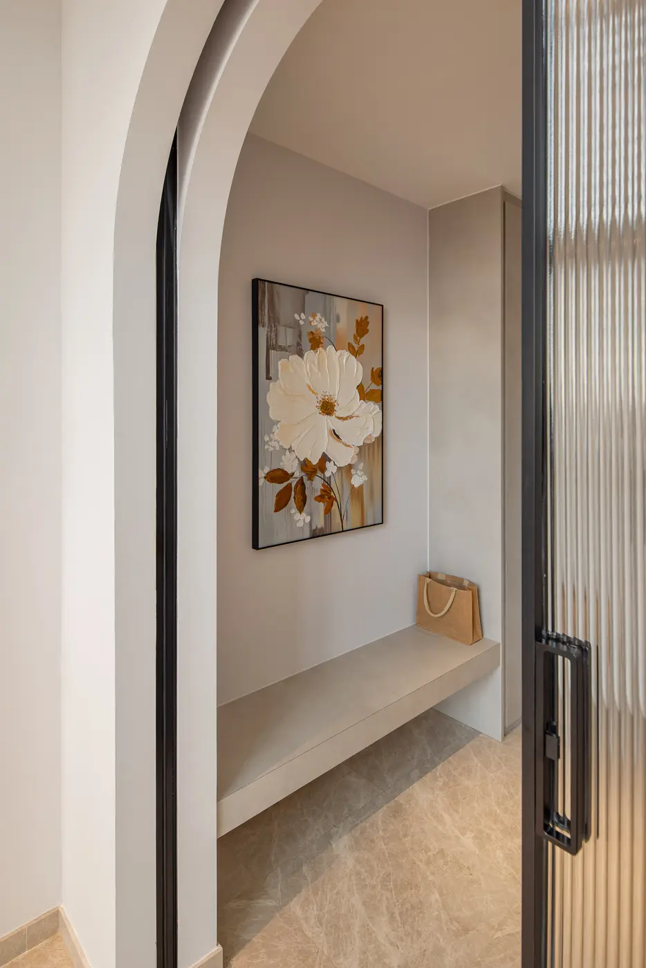 Entry foyer nook — arched recess with floral artwork and built-in bench