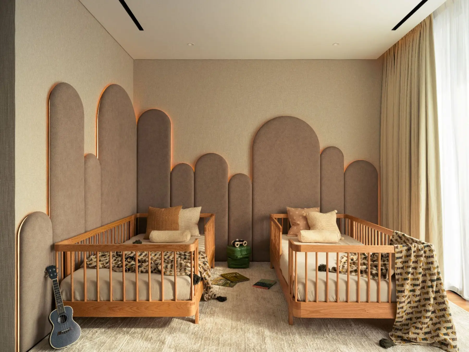 Children's twin bedroom — arched headboard panels rising behind twin cots
