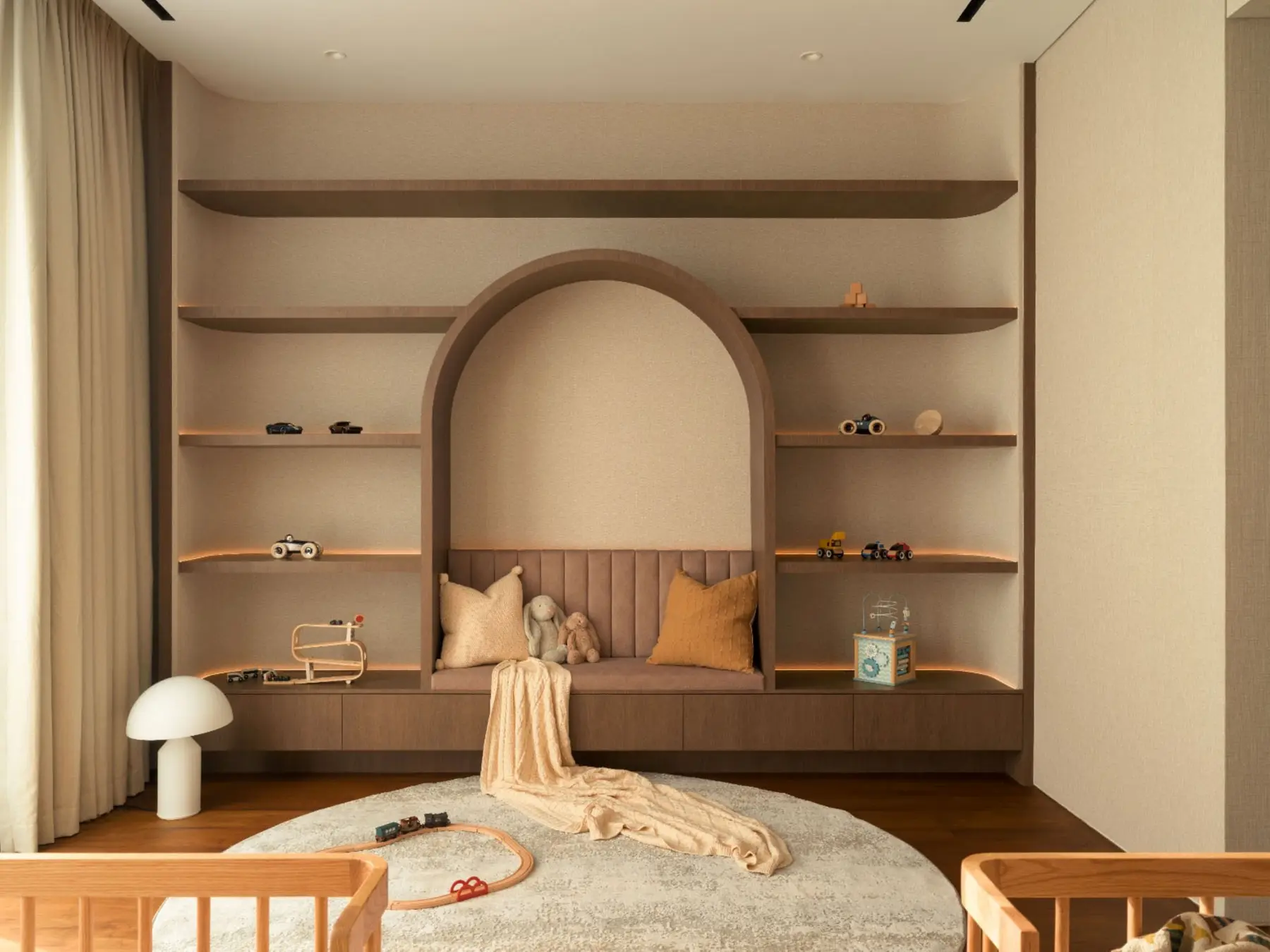 Children's reading nook — full-wall arched recess with floating shelves and built-in seating