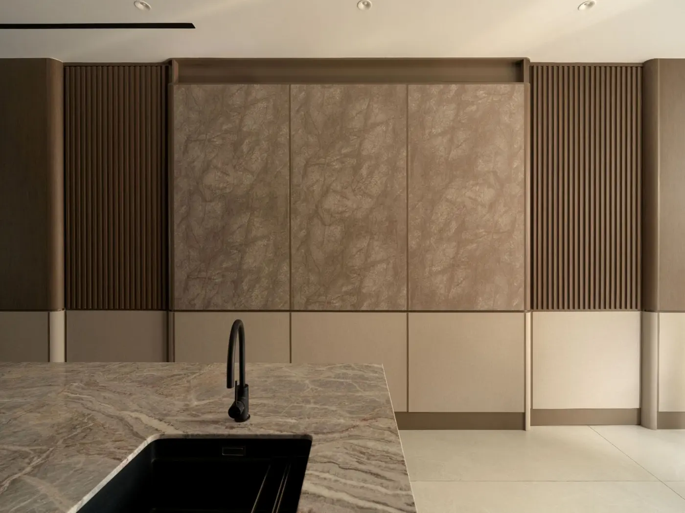 Kitchen — full backsplash wall with dramatic stone slab and timber cabinetry