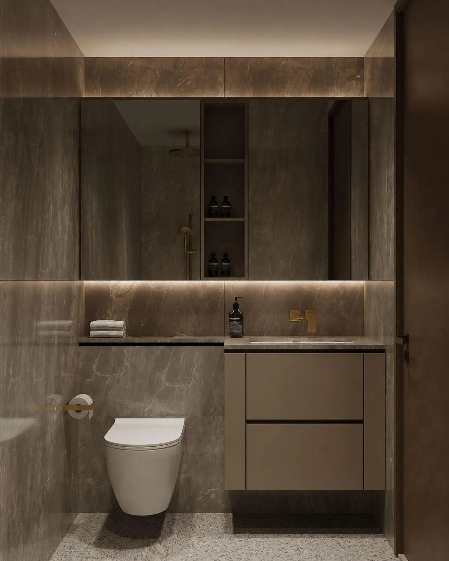 Secondary bathroom — dark smoky stone, wall-hung WC and warm overhead cove lighting