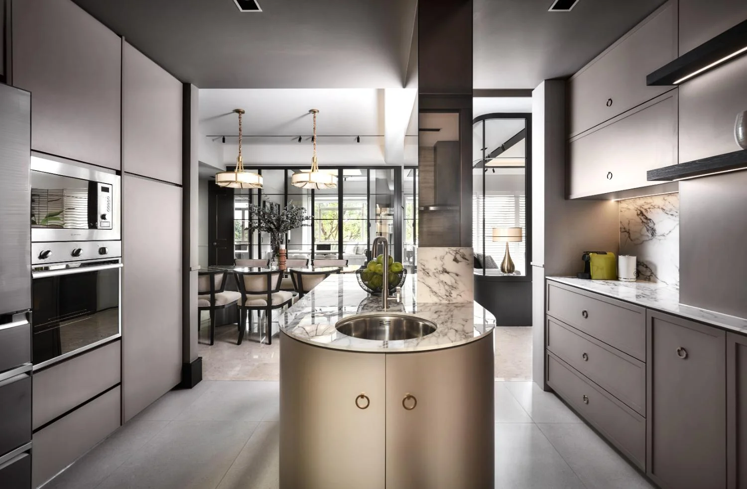 Kitchen wide shot — bespoke cabinetry, gold hardware, generous countertop and integrated appliances